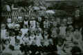 School pupils in yard, bakery visible behind them