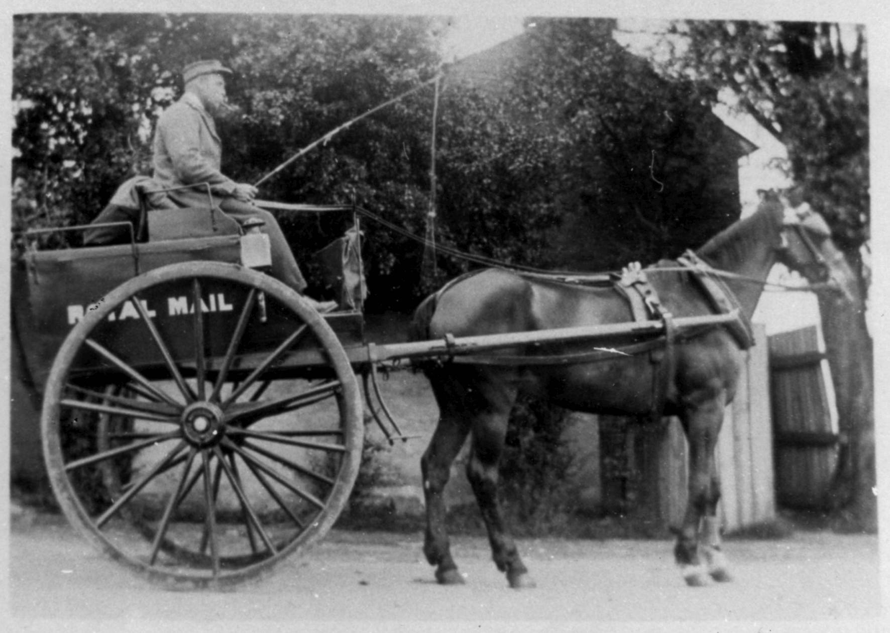 Postman on Royal Mail cart